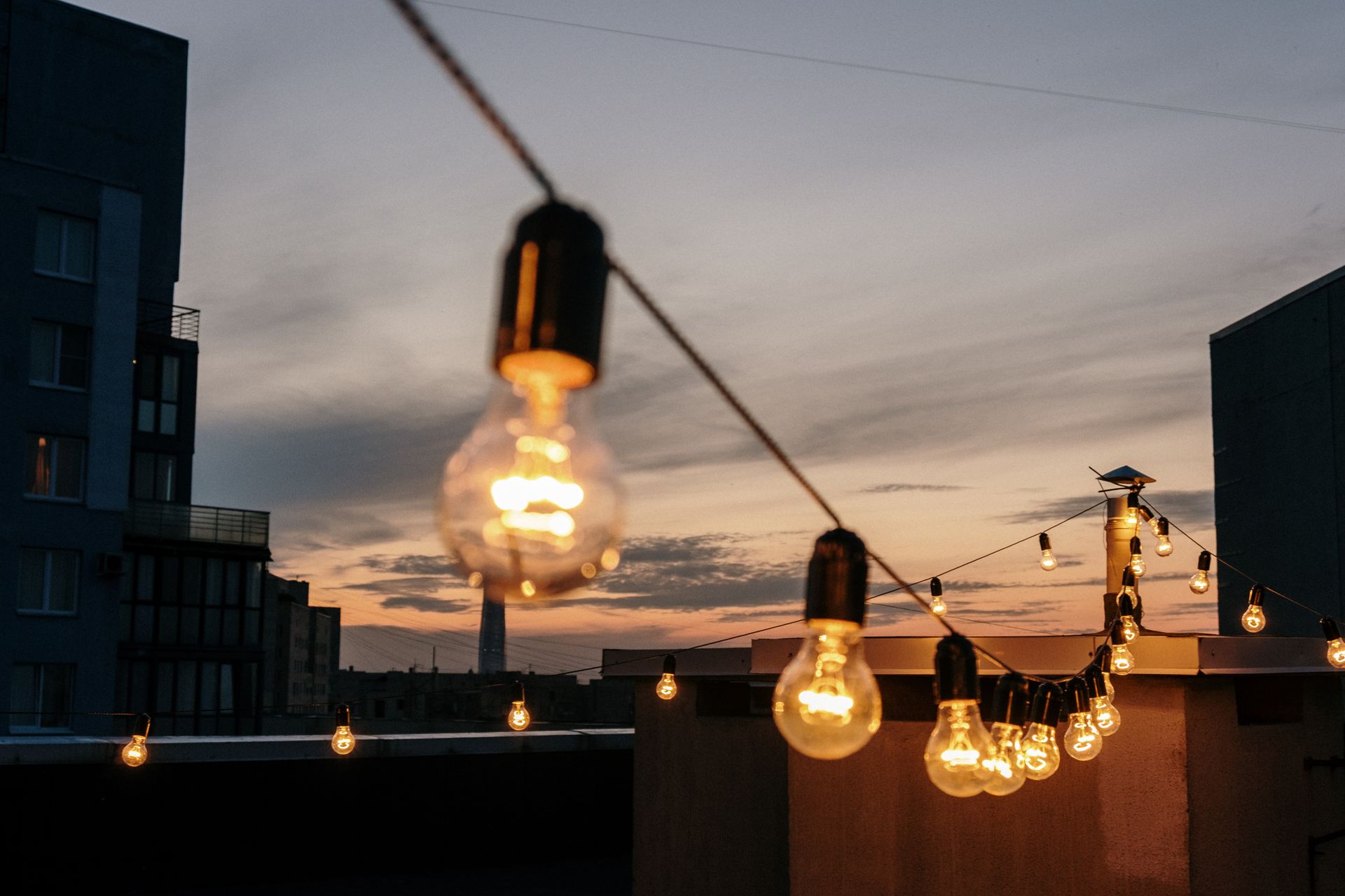 Cena romántica con luces cálidas en una azotea
